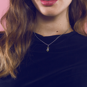 Sterling silver pendant with peridot set in an X shape